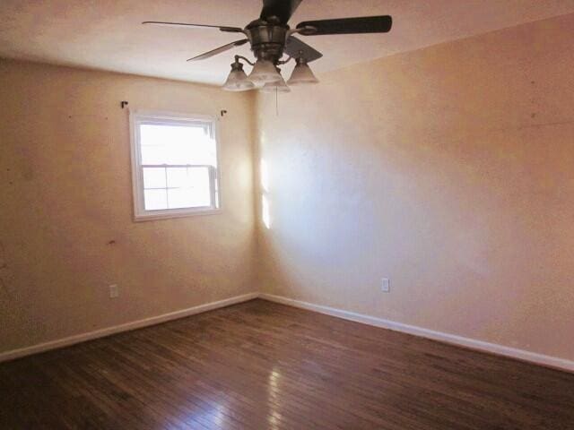 unfurnished room featuring dark hardwood / wood-style floors and ceiling fan