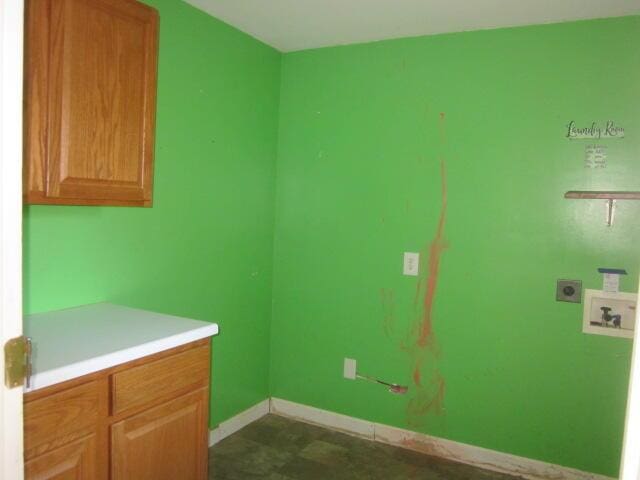 clothes washing area with cabinets, washer hookup, and hookup for an electric dryer