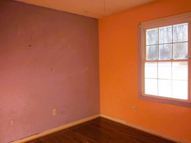 spare room featuring dark wood-type flooring