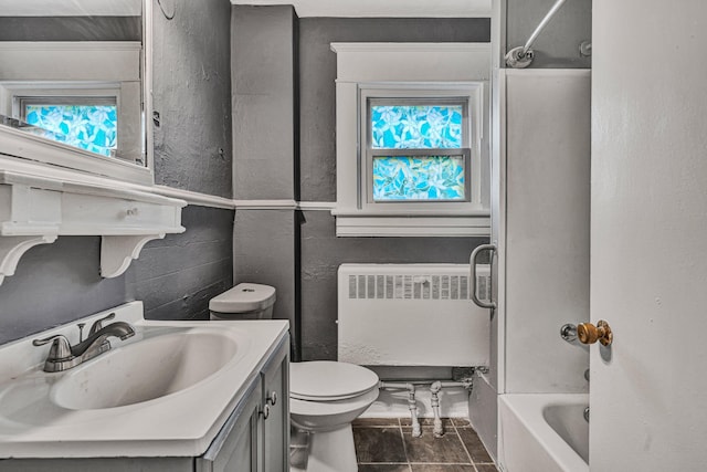 full bathroom with vanity, bathtub / shower combination, radiator heating unit, and toilet