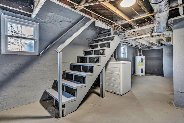 basement with water heater and washer / dryer