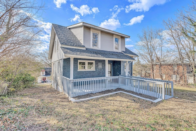 view of front property with a porch and a front yard
