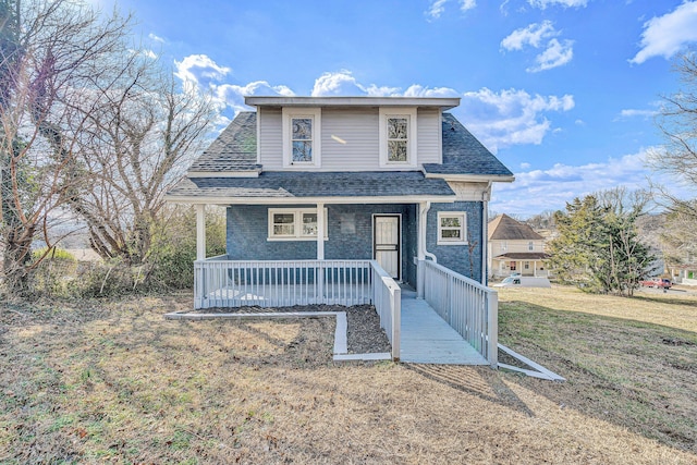 front of property featuring a porch and a front lawn