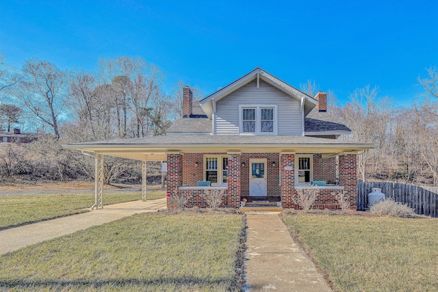 view of front facade with a porch, a carport, and a front lawn