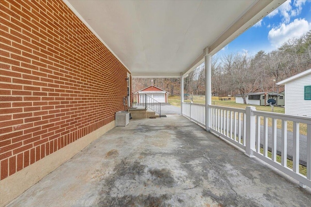 view of patio with a garage and an outdoor structure