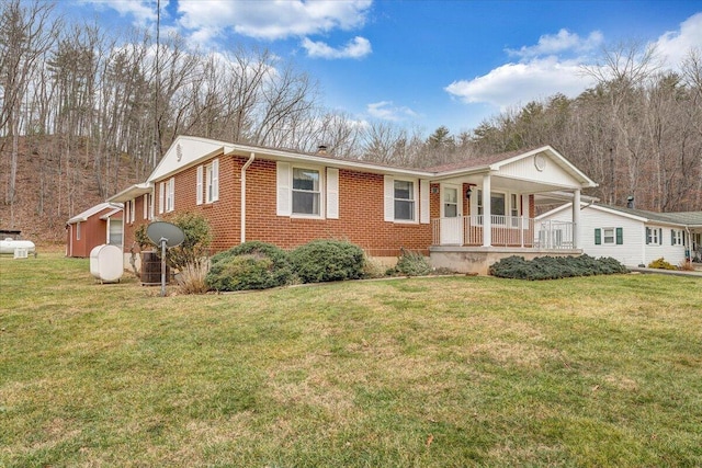 ranch-style house with a front lawn and covered porch