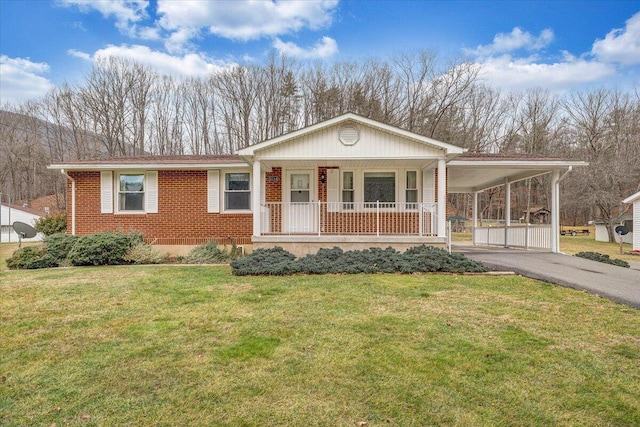 view of front facade with a carport, a porch, and a front yard