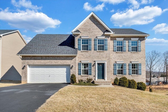 view of front of home featuring a garage and a front yard