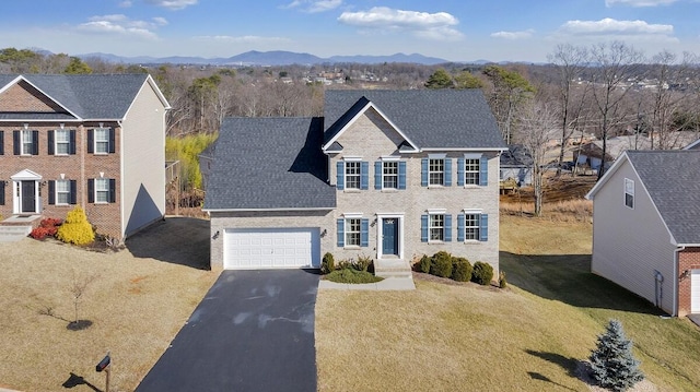 colonial inspired home featuring a mountain view and a front yard