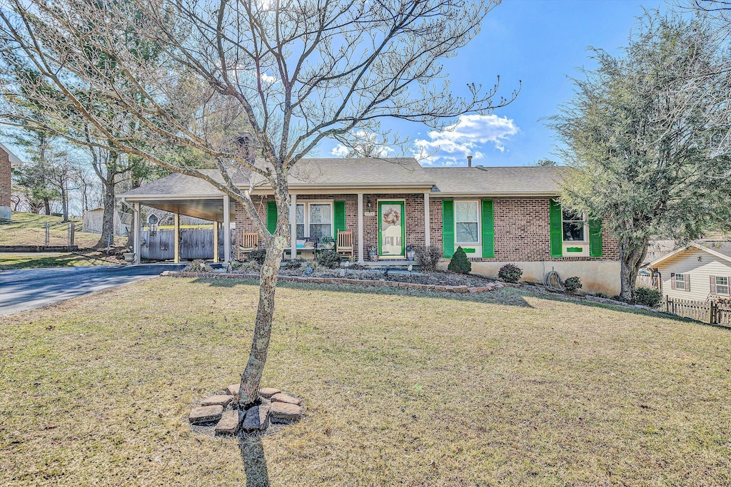 ranch-style home with a front lawn and a carport