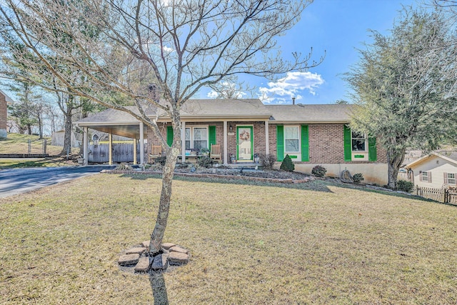 ranch-style home with a front lawn and a carport