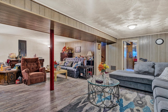 living room featuring wood-type flooring and electric panel