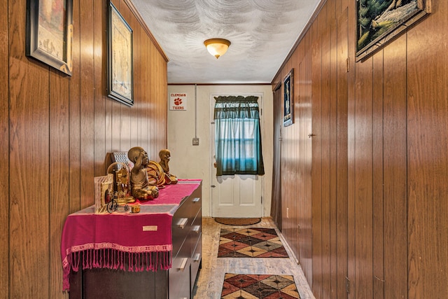 doorway to outside with wooden walls