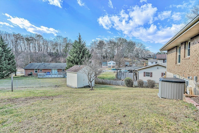 view of yard with cooling unit and a storage shed