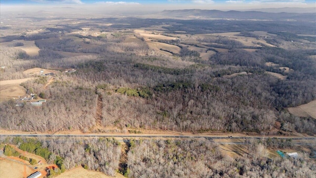 drone / aerial view with a mountain view and a wooded view