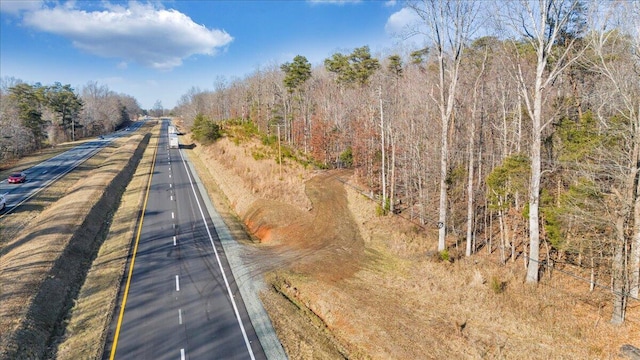 view of street featuring a wooded view