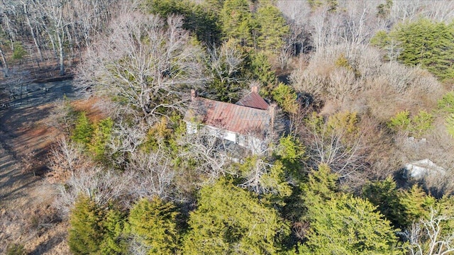 birds eye view of property with a view of trees