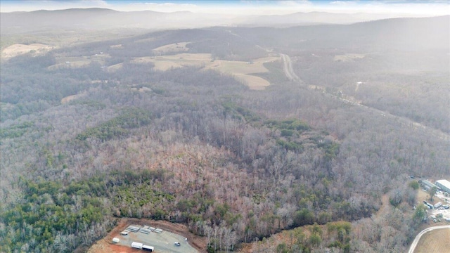 aerial view featuring a mountain view and a wooded view