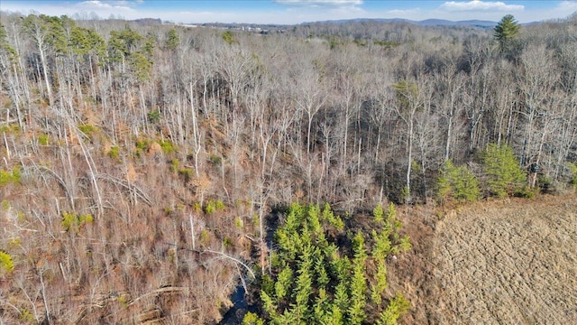 drone / aerial view with a wooded view