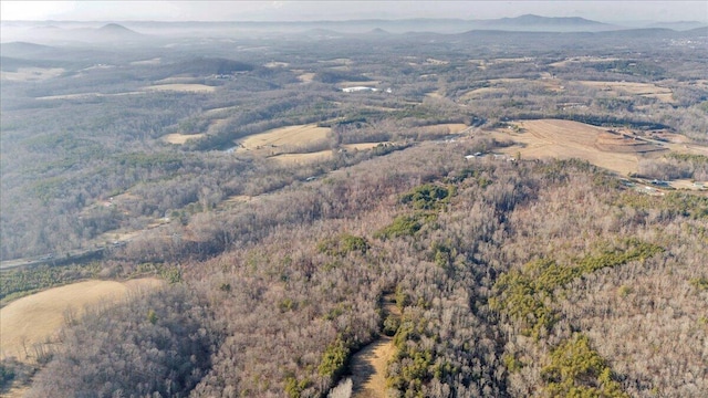 aerial view featuring a forest view and a mountain view