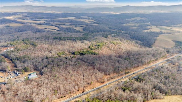 birds eye view of property featuring a mountain view and a wooded view