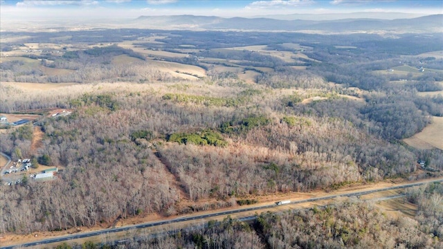 drone / aerial view with a mountain view and a forest view