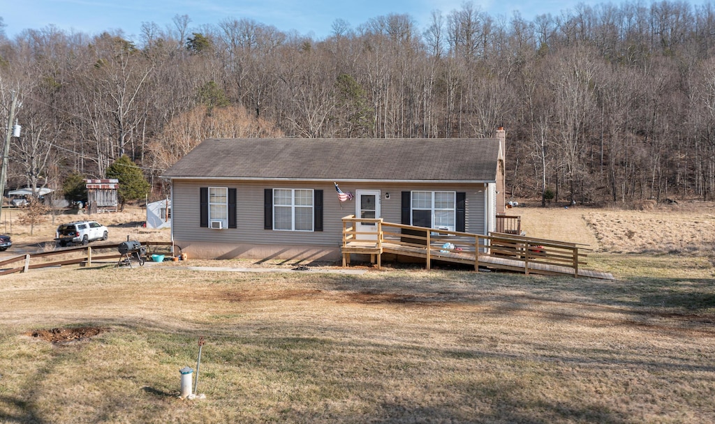 view of front facade with a front yard and a deck