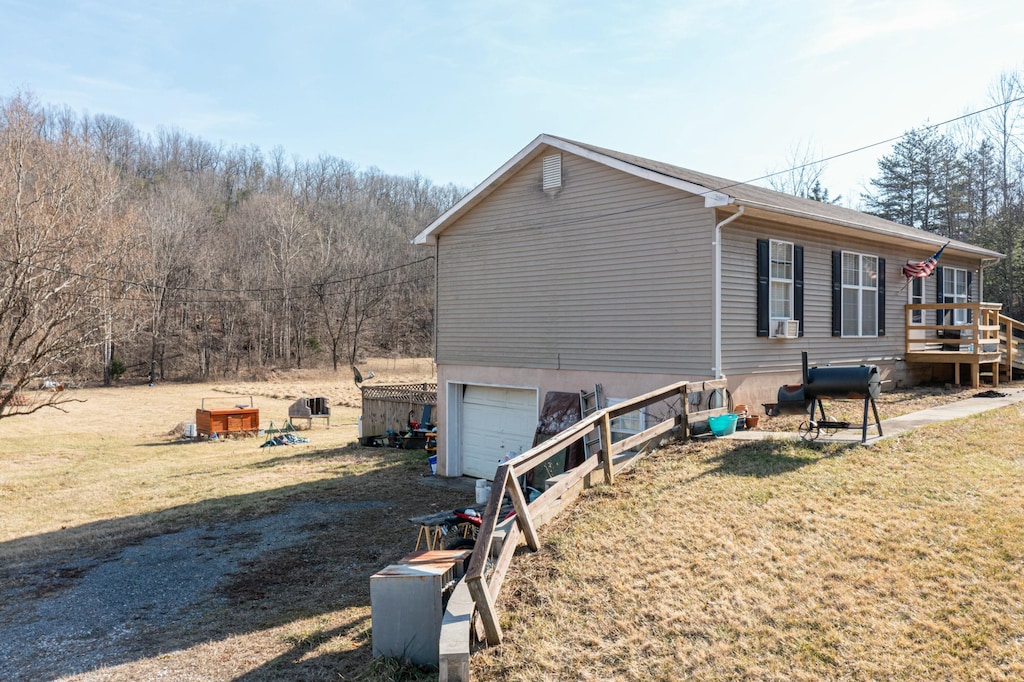 view of property exterior featuring a yard and a garage