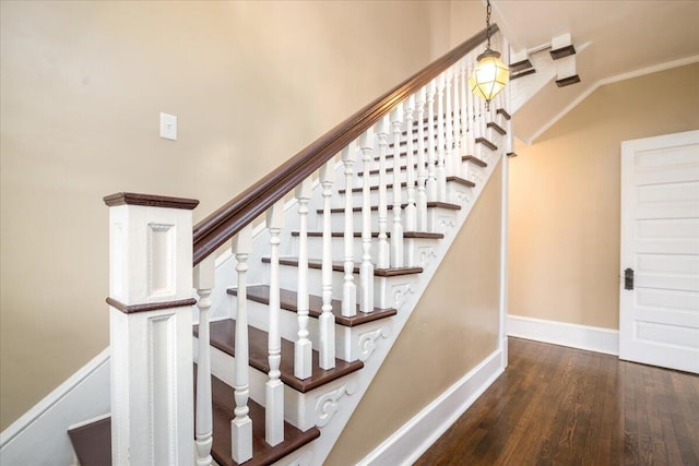 stairs featuring ornamental molding and wood-type flooring