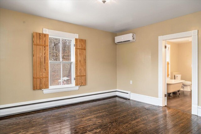 unfurnished room featuring a baseboard heating unit, wood-type flooring, a wall mounted AC, and plenty of natural light