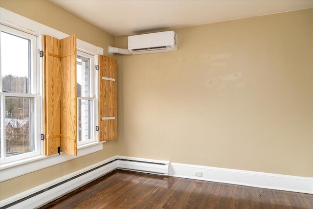 empty room featuring hardwood / wood-style floors, a wall mounted AC, and baseboard heating