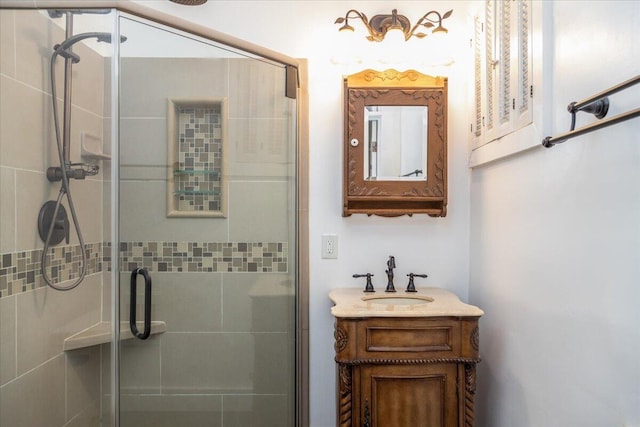 bathroom featuring vanity and a shower with door