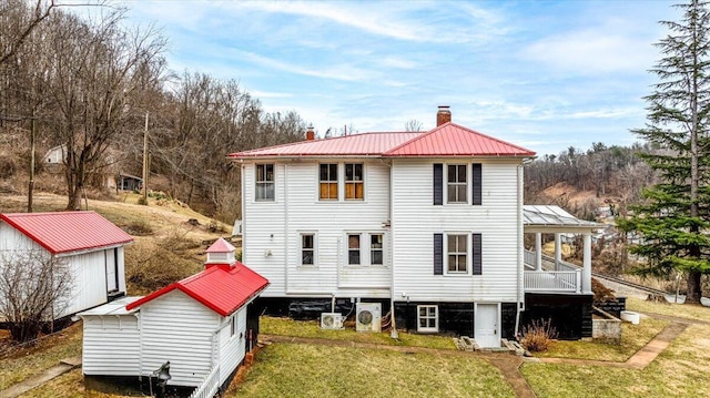 rear view of property with a lawn