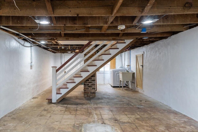 basement featuring washer / clothes dryer and sink