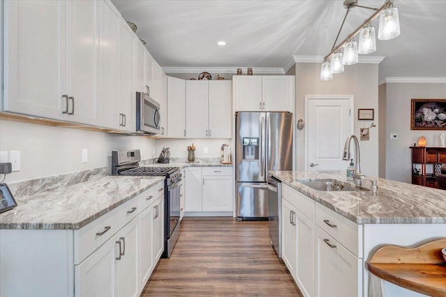 kitchen featuring sink, crown molding, stainless steel appliances, and white cabinets