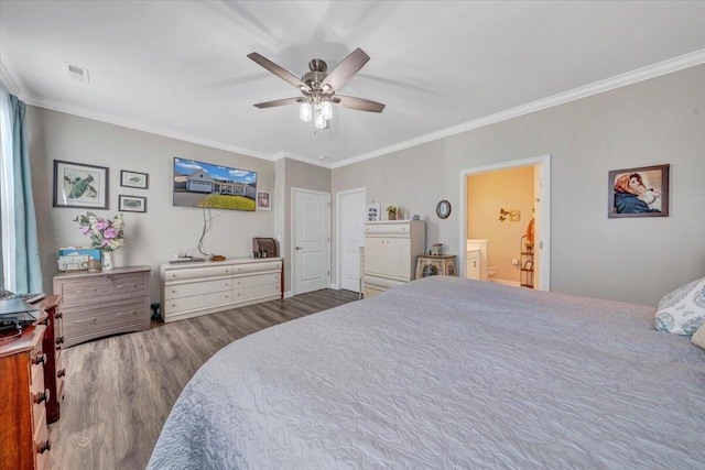 bedroom with ornamental molding, hardwood / wood-style floors, ceiling fan, and ensuite bath