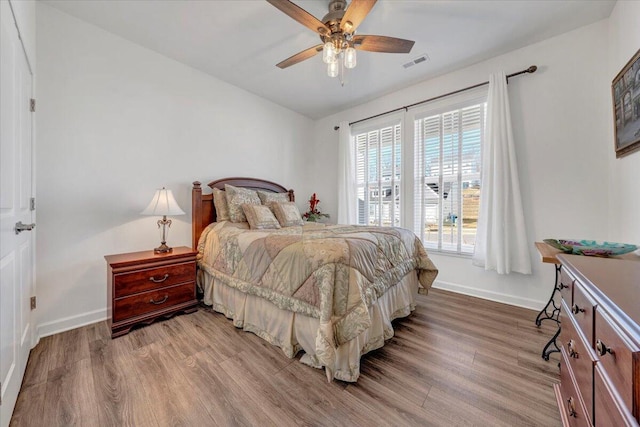 bedroom featuring lofted ceiling, ceiling fan, and light wood-type flooring