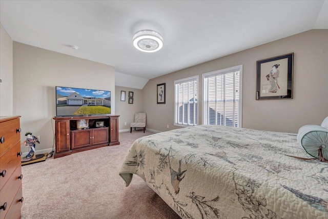 bedroom featuring lofted ceiling and carpet