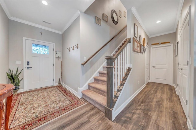 foyer with crown molding and hardwood / wood-style floors