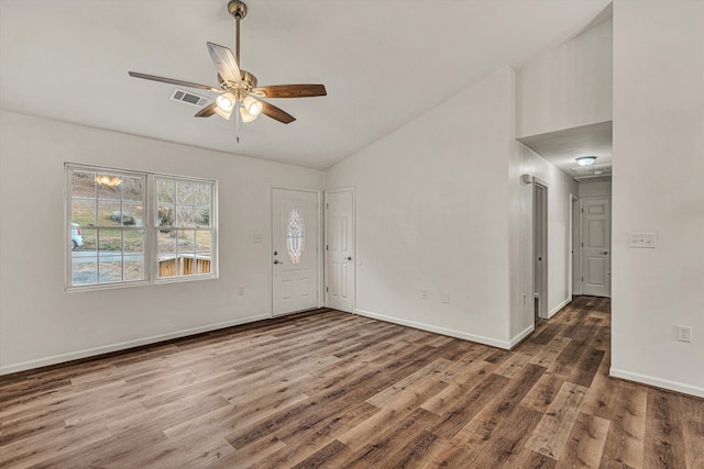 foyer entrance with vaulted ceiling, dark hardwood / wood-style floors, and ceiling fan