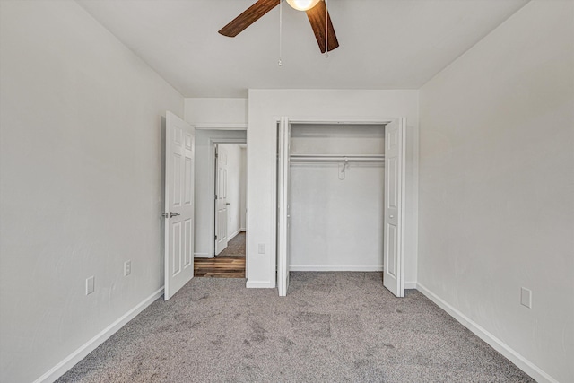 unfurnished bedroom with ceiling fan, light colored carpet, and a closet