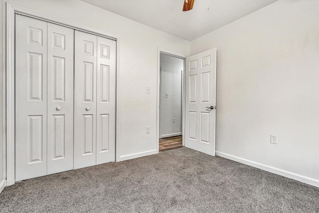 unfurnished bedroom featuring ceiling fan, carpet flooring, and a closet