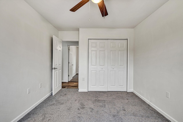 unfurnished bedroom featuring ceiling fan, a closet, and carpet