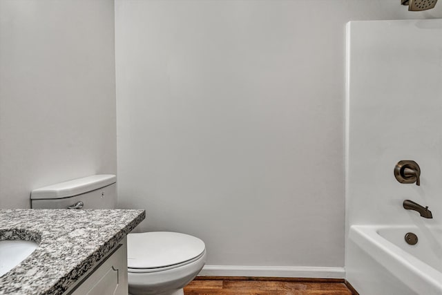 full bathroom with hardwood / wood-style flooring, shower / tub combination, vanity, and toilet