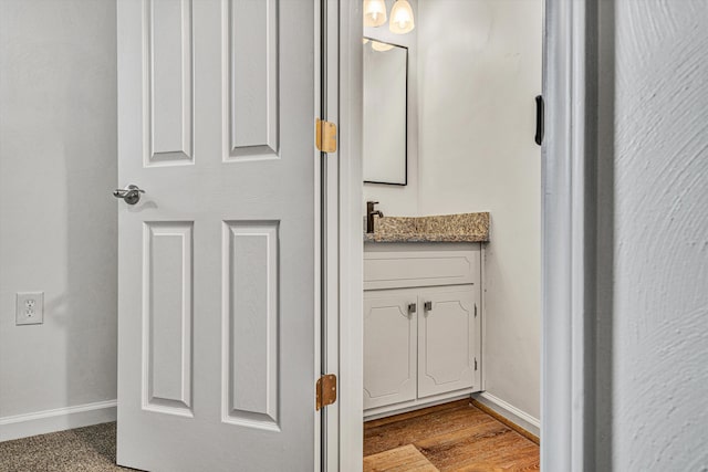 bathroom with vanity and hardwood / wood-style floors