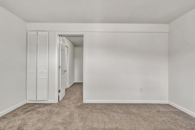 empty room featuring light carpet and ornamental molding