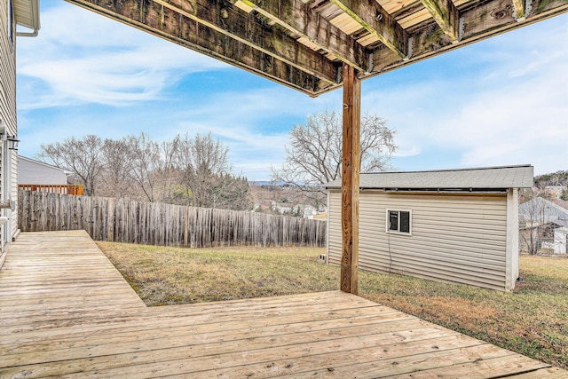 wooden deck featuring a lawn