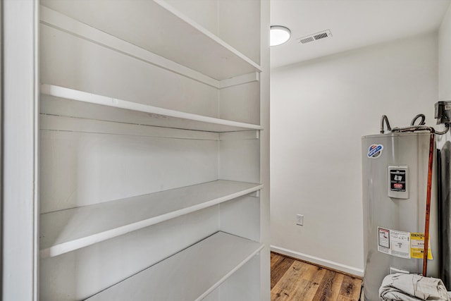 utility room featuring water heater