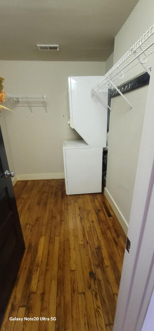 spacious closet with dark hardwood / wood-style flooring