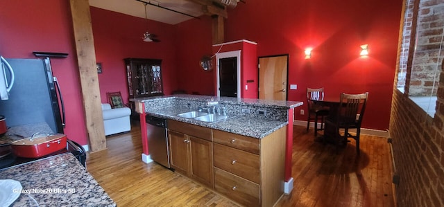 kitchen featuring sink, stone counters, light hardwood / wood-style floors, and dishwasher